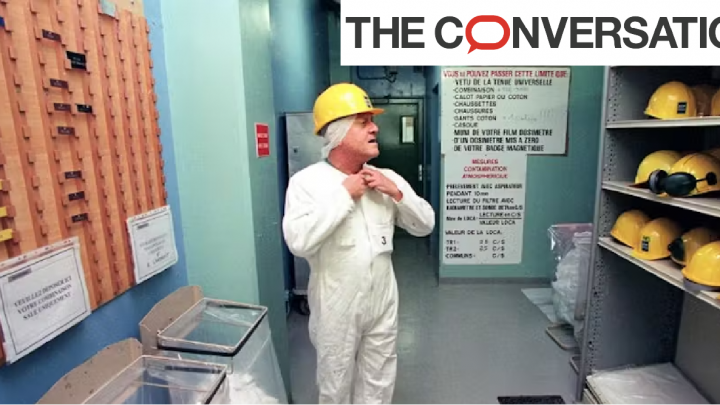 Ouvrier de centrale nucléaire en train d'enfiler ses équipements de protection individuelle