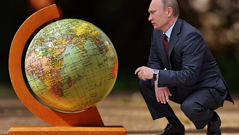 Vladimir Poutine agenouillé devant une mappemonde